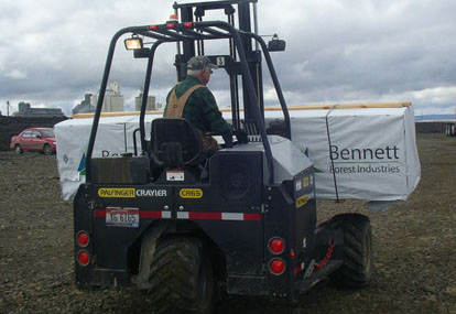 Palfinger CR65 Crayler forklift moving materials over rough terrain to job site.