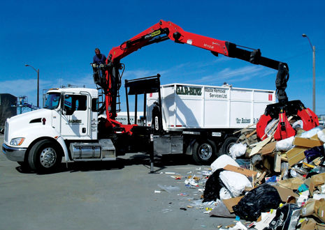 The Epsilon M110Z makes quick work of mounds of recycling at a processing center.