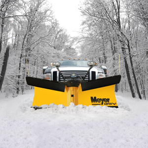 Meyer Super-V Snow Plow mounted on Ford pickup traveling down snowy tree lined road.